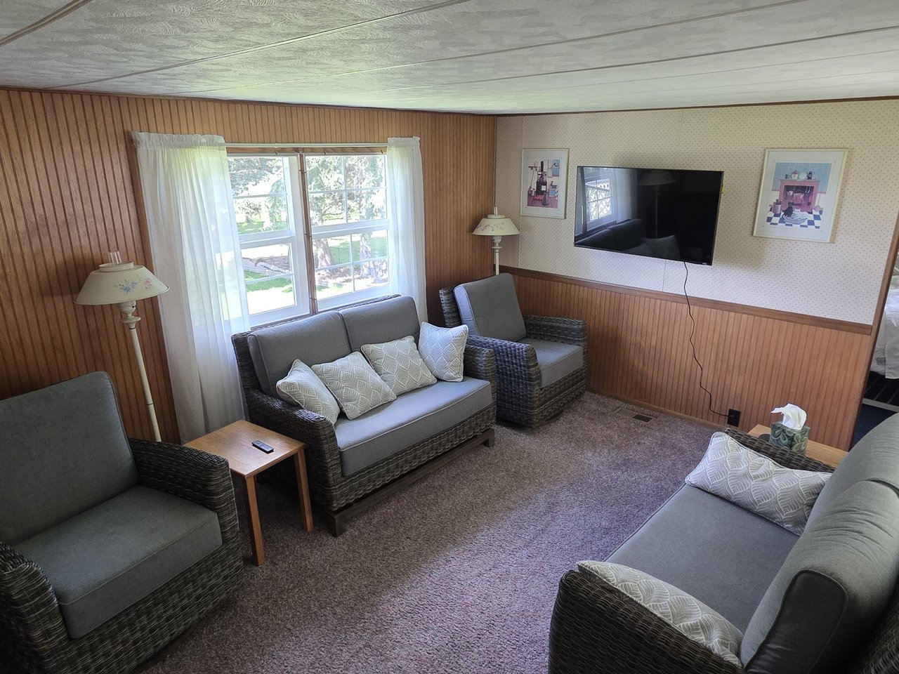 The rec room with a smart TV and lounge seating