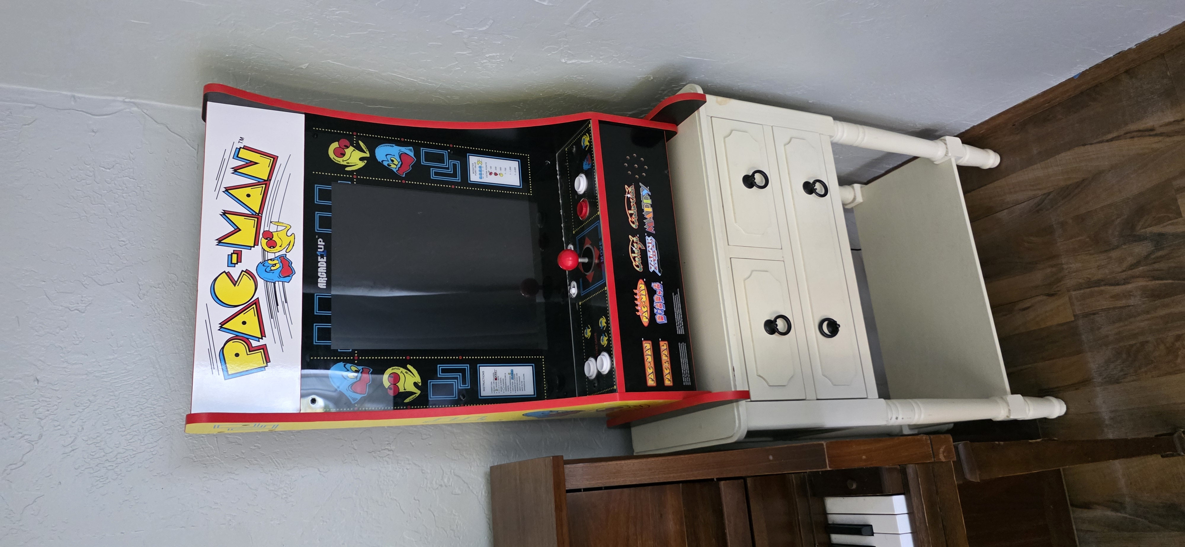 Piano and arcade game corner at The Last Acre